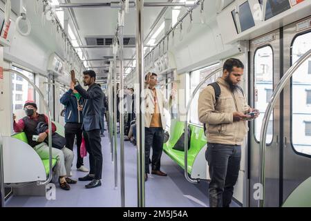 Passengers travel inside a Dhaka Metro train from Uttara North to Agargaon. Prime Minister Sheikh Hasina formally inaugurated the country's first metro rail. Stock Photo