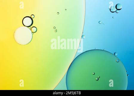 Multi-coloured bubble patterns formed by oil floating on water Stock Photo