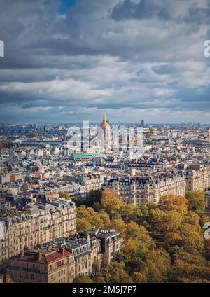 Scenery aerial view from the Eiffel tower height over the Paris city, France. Les Invalides building with golden dome seen on the horizon. Autumn pari Stock Photo
