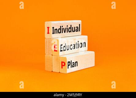 IEP individual education plan symbol. Concept words IEP individual education plan on wooden blocks on beautiful orange background. Business IEP indivi Stock Photo