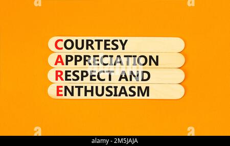 CARE symbol. Concept words CARE courtesy appreciation respect and enthusiasm on wooden stick on beautiful orange background. Business CARE courtesy ap Stock Photo