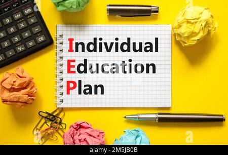 IEP individual education plan symbol. Concept words IEP individual education plan on white note on a beautiful yellow background. Calculator. Business Stock Photo