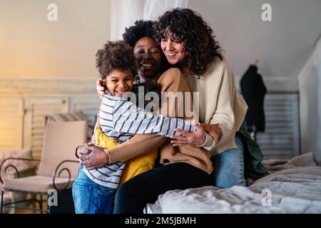 Gay couple children love happiness concept. Happy multiethnic family spending time together at home Stock Photo