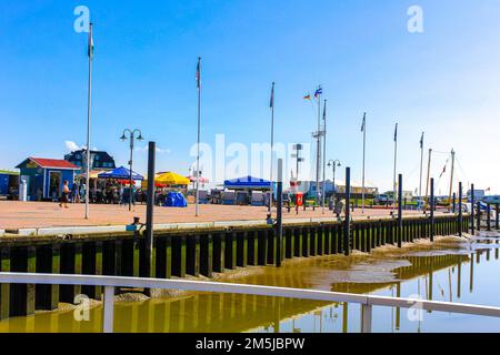 Hiking in mudflats and mud on the dike and sea in Wremen Wurster North Sea coast Wursten Cuxhaven Lower Saxony Germany. Stock Photo