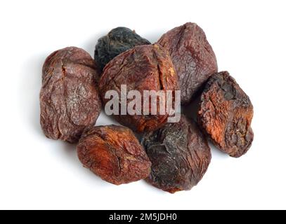 Whole Sun-dried apricots with stones. Isolated on white background. Stock Photo