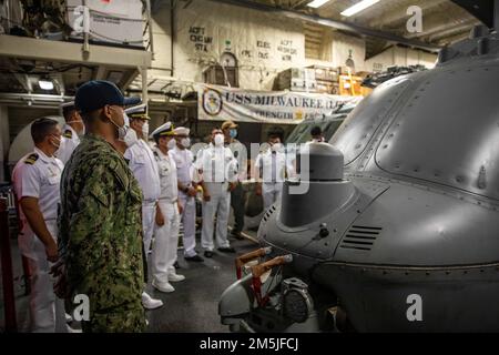 220319-N-HD110-1048  MANTA, Ecuador - (March 19, 2022) -- Aviation Machinist’s Mate 3rd Class Felix Ricoospina, assigned to the “Sea Knights” of Helicopter Sea Combat (HSC) Squadron 22, Detachment 5, discusses the capabilities of an MQ-8C Fire Scout to members of the Ecuadorian navy during their visit to the Freedom-variant littoral combat ship USS Milwaukee (LCS 5), March 19, 2022. Milwaukee is deployed to the U.S. 4th Fleet area of operations to support Joint Interagency Task Force South’s mission, which includes counter-illicit drug trafficking missions in the Caribbean and Eastern Pacific. Stock Photo