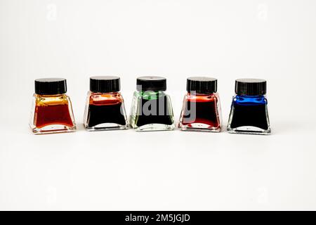 selection of artists india ink in glass bottles isolated on a white background Stock Photo