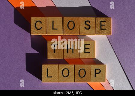 Close The Loop business buzzword phrase meaning to follow up and finish an area of discussion, in wooden alphabet letters isolated on background Stock Photo