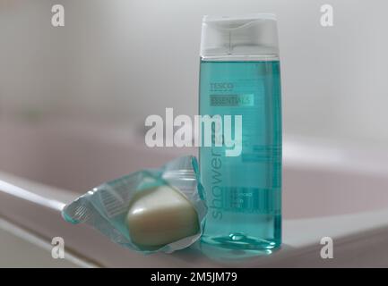 A bottle of Tesco’s budget range Essentials shower gel and Essentials soap in a bathroom. Stock Photo
