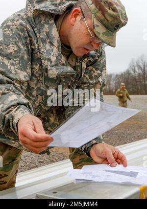 U.S. Army Sgt. 1st Class Jason Darrow, a senior instructor with Company A, 4th Battalion, 399th Regiment, reviews the accuracy of a team’s plotted points prior to the start of land navigation training March 19 on Fort Knox. Ky. Soldiers from 4th Bn., 399th Regt., who serve as Cadet Summer Training instructors, conducted land navigation refresher training before traversing the course to find their specified points during March Battle Assembly. Stock Photo