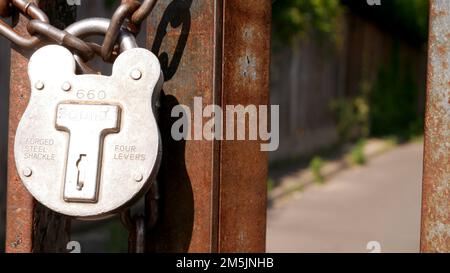 Padlock and chain on a park gate Stock Photo