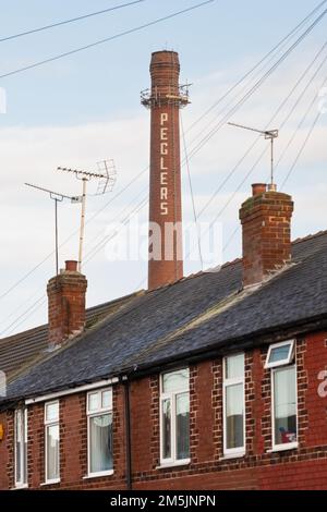 Terraced housing and Peglers chimney, Balby, Doncaster, South Yorkshire, England UK Stock Photo