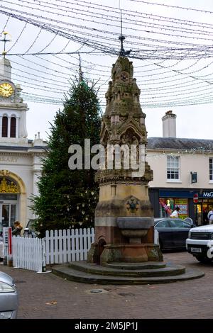 Very old drinking fountain next to an illuminated Christmas tree in Saffron Walden, Essex, UK Stock Photo