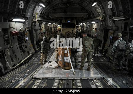 U.S. Soldiers assigned to the 110th Chemical Battalion participate in technical escort mission and Chemical, Biological, Radiological, Nuclear, and Explosives training during Operation Iron Flight, aboard a C-17 Globemaster III aircraft, March 20, 2022, Joint Base Lewis-McChord, Washington. The pre-planned exercise in partnership with exercise Rainier Kraken is designed to demonstrate the joint forces’ ability to operate and survive in all operating domains – air, land, and cyberspace. Stock Photo