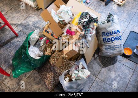 Discarded Christmas present wrapping paper in plastic bags ready for throwing into the rubbish. The paper cannot currently be recycled. England Stock Photo