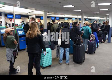 Passengers wait in line to check in luggage at the Southwest Airlines ticket counter at the Hollywood Burbank Airport, Monday, Dec. 26, 2022, in Burbank, Calif. Stock Photo