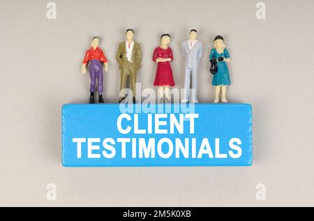 Business concept. On the blue block the inscription - CLIENT TESTIMONIALS. There are figures of people on the block. Stock Photo