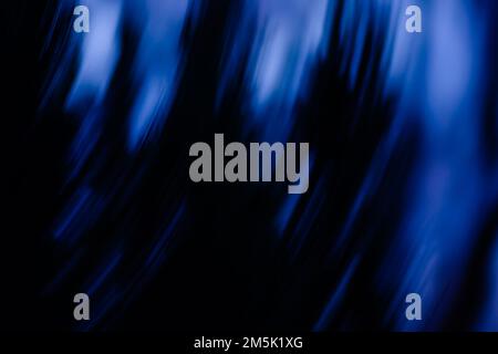 Blurry mysterious Halloween horror backdrop. Mystical motion bokeh Halloween horror backdrop in magical light. Stock Photo