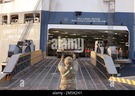 An M1 Abrams main battle tank is the first of nearly 200 vehicles and equipment items from 3rd Armored Brigade Combat Team, 4th Infantry Division to arrive in Europe aboard the “Liberty Passion”, a commercial cargo vessel, which docked in Alexandroupoli, Greece, March 21, 2022. The 3rd ABCT is the ninth armored rotational unit to deploy to Europe in support of Atlantic Resolve. The “Iron Brigade” will join two other brigades in Europe under the command of U.S. Army V Corps, which retains command control of all rotational units in the European theater. The rotation will include joint and multin Stock Photo