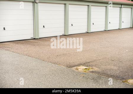 Mölndal, Sweden - July 31 2022: Six white garage ports at a parking lot Stock Photo