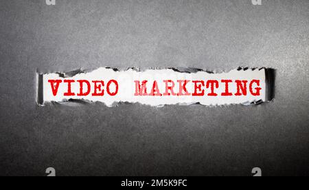 Video Marketing - using videos to promote and market your product or service, text concept on notepad. Stock Photo