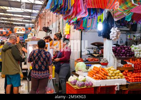 People lining-up at a stall selling prepared meats at Lucas de Galvez Market in the center of Merida, Yucatan, Mexico Stock Photo