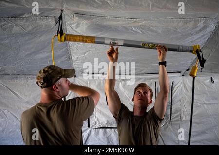Airmen work together to setup tent city during the Deployable Air Base ...
