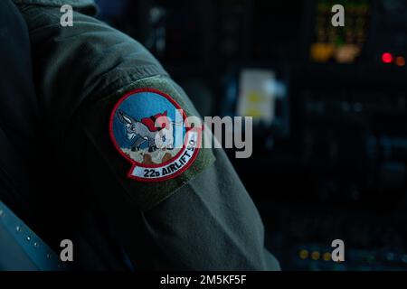 U.S. Air Force Staff Sgt. Clark Alexis, 22nd Airlift Squadron flight engineer, wears a 22nd AS patch on her flight suit at Travis Air Force Base, California, March 22, 2022. Flight engineers are responsible for monitoring all aircraft engine and control systems while in-flight. They also perform pre-flight and post-flight inspections. Stock Photo
