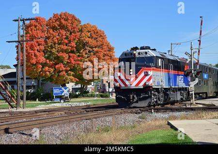 Bartlett, Illinois, USA. A Metra commuter train after departing the local commuter train station on a bright autumn day on its journey from Chicago. Stock Photo