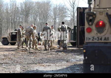 Soldiers assigned to 2nd Battalion, 34th Armored Regiment, 1st Armored Brigade Combat Team, 1st Infantry Division, discuss their route to conduct a Humvee road test at Drawsko Pomorskie Training Area, Poland, March 23, 2022. Stock Photo