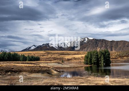 Scenic view of Lake Tekapo east bank. Beautiful view driving along the Lilybank Road from Lake Tekapo Park towards Motuariki View Point. Stock Photo