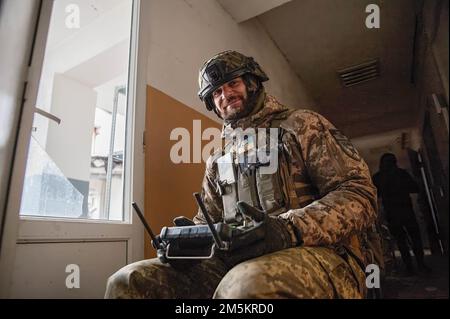 Leonid, a Ukrainian drone operator smiles as he works to correct artillery fire in the city of Bahkmut. Fighting in the city has continued for weeks, causing immense destruction within the city. Stock Photo