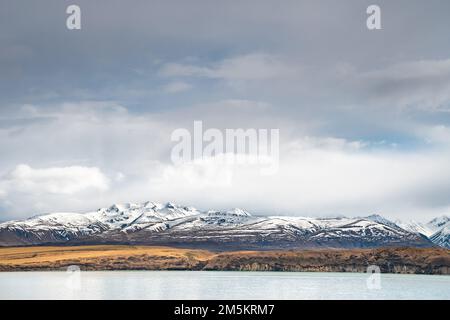 Scenic view of Lake Tekapo east bank. Beautiful view driving along the Lilybank Road from Lake Tekapo Park towards Motuariki View Point. Stock Photo