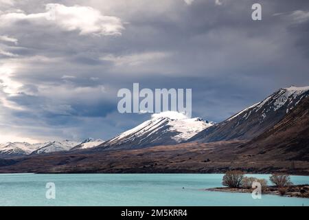 Scenic view of Lake Tekapo east bank. Beautiful view driving along the Lilybank Road from Lake Tekapo Park towards Motuariki View Point. Stock Photo