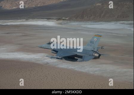 An F-16C Fighting Falcon assigned to the 64th Aggressor Squadron participates in a routine training mission March 23, 2022, over the Nevada Test and Training Range at Nellis Air Force Base. The 64th AGRS operates 30 F-16C/M aircraft, providing realistic, threat-representative, opposing forces for high-end US and coalition training. Stock Photo