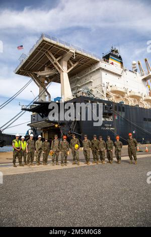 U.S. Marines participating in Atlantic Dragon pose for a photo aside the Military Sealift Command cargo ship USNS 1st Lt. Jack Lummus (T-AK 3011) during exercise Atlantic Dragon on Marine Corps Support Facility Blount Island, Florida, United States, March 23, 2022. Atlantic Dragon is a force generation exercise pushing Combat Logistics Regiment 37 as an arrival assembly operations group to provide tactical logistics support to III Marine Expeditionary Force. The exercise consists of an experimental maritime prepositioned force's offload tactics of military equipment that will support the field Stock Photo