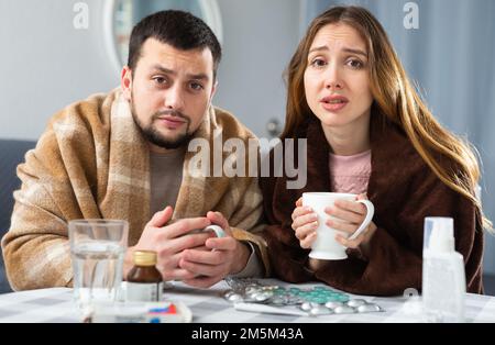 Sick couple suffering from flu at home Stock Photo