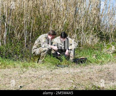 Two U.S. Air Force Joint Terminal Attack Controllers conduct ramp checks at Andravida Air Base, Greece, March 24, 2022. JTACs perform ramp checks – conducting radio and video downlink, and digital messaging checks before mission execution in order to ensure success. Stock Photo