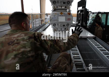 Airmen assigned to the 305th Aerial Port Squadron secure a pallet of equipment on Joint Base McGuire-Dix-Lakehurst, N.J., Mar. 24, 2022. The 305th Air Mobility Wing is sending equipment to Europe as part of the United States security assistance to Ukraine. The United States supports Ukraine’s sovereignty and territorial integrity. Stock Photo