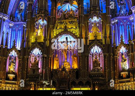 Notre-Dame Basilica of Montreal. inside the Catholic Church - ancient decoration, Gothic style, stained glass windows, columns, altar with icons. Stock Photo