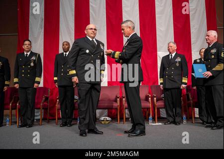 MILLINGTON, Tenn. (March 25, 2022) Rear Adm. Pete Garvin, commander, Naval Education and Training Command, right, presents Rear Adm. Dennis Velez a Legion of Merit award during the 2022 Navy Recruiting Command (NRC) Change of Command ceremony in Millington, March 25. The goal of NRC is to attract the highest quality candidates to assure the ongoing success of America’s Navy. Stock Photo