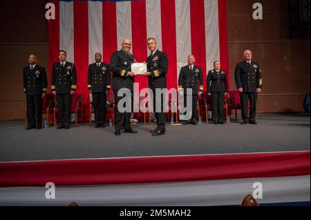 MILLINGTON, Tenn. (March 25, 2022) Rear Adm. Pete Garvin, commander, Naval Education and Training Command, right, presents Rear Adm. Dennis Velez a Legion of Merit award during the 2022 Navy Recruiting Command (NRC) Change of Command ceremony in Millington, March 25. The goal of NRC is to attract the highest quality candidates to assure the ongoing success of America’s Navy. Stock Photo