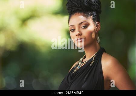 Style inspired by nature. Portrait of an attractive young woman posing outdoors. Stock Photo