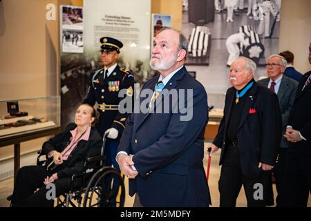 Allison Finkelstein, historian, Arlington National Cemetery, gives a tour of the Memorial Amphitheater Display Room to Medal of Honor Recipients U.S. Army 1st Lt. Brian Thacker and U.S. Marine Corps Col. (ret.) Barney Barnum at Arlington National Cemetery, Arlington, Va., March 25, 2022. Stock Photo