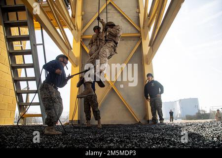 New U.S. Marines with India Company, 3rd Recruit Training Battalion, descends down the rappel tower on Marine Corps Recruit Depot San Diego, March 25, 2022.The Marines began the event by learning how to make their own harnesses to descend the 60-foot tower. Stock Photo