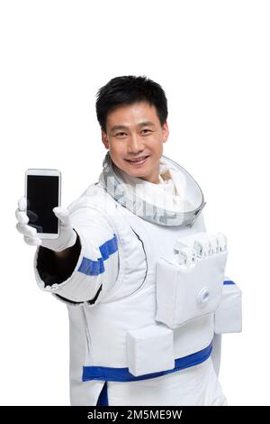 Shed male astronauts display mobile phone Stock Photo