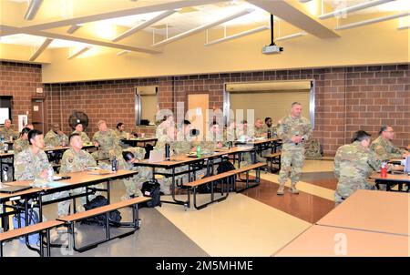 Col. Eric Rahman, 505th Theater Tactical Signal Brigade commander, addresses Soldiers from the 319th Expeditionary Signal Battalion, 98th ESB and 505th Headquarters-Headquarters Company, assembled in the 4th Sustainment Command (Expeditionary) drill hall, who traveled to Fort Sam Houston, Texas, to conduct the Scorpion Brigade Leader Workshop, March 24-27, 2022. The 505th TTSB deploys to conduct mission command and provide network planning and engineering support for assigned units. Stock Photo