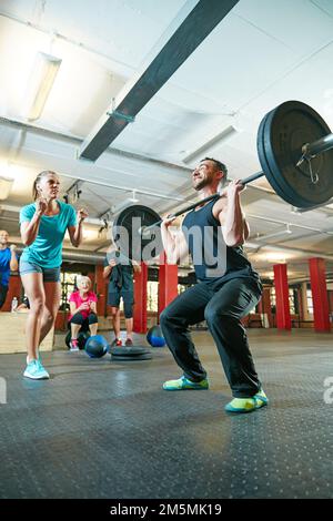 Either you do it or you dont. a fitness instructor motivating her client during their workout session. Stock Photo