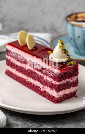 Raspberry cake on a dark background. Layered raspberry cake slice. Bakery cake products. close up Stock Photo