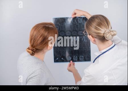 Female doctor explaining mri of internal organs to female patient.  Stock Photo
